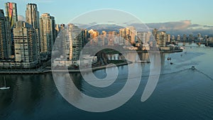 Aerial view of skyscrapers in Downtown, False Creek, boats in marina at sunset