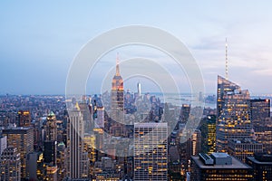 Aerial view of skyscrapers of Lower Manhattan and Empire State Building at dusk