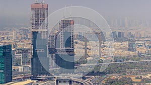 Aerial view of skyscrapers under construction in Dubai timelapse.