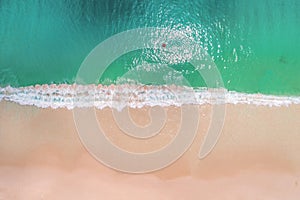 Aerial view of slim woman swimming on the swim ring donut in the transparent turquoise sea in Seychelles. Summer seascape with