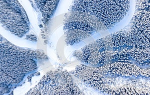 Aerial view at the slope on ski resort. Forest and ski slope from air. Winter landscape from a drone. Snowy landscape on the ski r