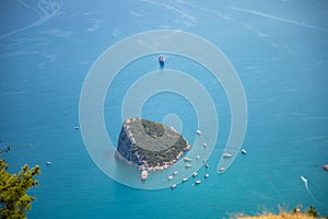 Aerial view of small Antalya Rat Island and diving boats in Mediterranean sea, Antalya, Turkey