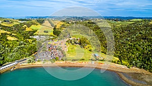 Aerial view on a small beach with a parking ground on the foreground. Waiheke Island, Auckland, New Zealand