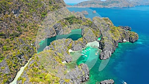 Aerial view of small and big lagoon on Miniloc Island. El-Nido, Palawan. Philippines. Limestone rock formation overgrown