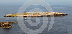 Aerial view of a small boat sailing near Islas Baleares in Spain