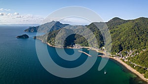Aerial view of small coastal beach town by mountains on Shodo Island photo