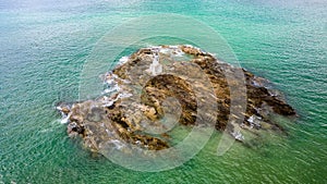 Aerial view of a small lighthouse off the tropical Nangthong Beach in Khao Lak, Thailand