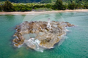 Aerial view of a small lighthouse off the tropical Nangthong Beach in Khao Lak, Thailand