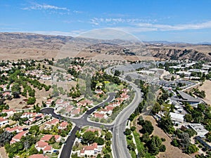 Aerial view of small neighborhood with dry desert mountain on the background in Moorpark