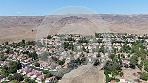 Aerial view of small neighborhood with dry desert mountain on the background in Moorpark