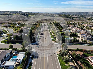 Aerial view of small neighborhood road with residential modern subdivision luxury houses