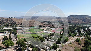 Aerial view of small neighbourhood with dry desert mountain on the background in Moorpark