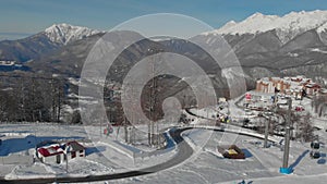 aerial view of small picturesque ski resort, funicular and hotels for tourists and sportsmen, winter shot