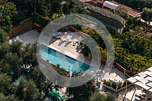 Aerial view of small rectangle swimming pool in olive trees, Italy, travel vacation concept