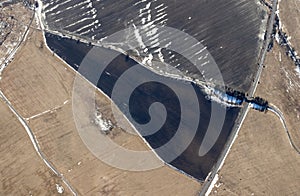 Aerial view of a small settlement with fields, triangle. Agricultural landscape