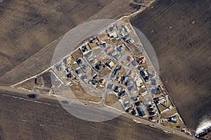 Aerial view of a small settlement with fields, triangle. Agricultural landscape with houses.