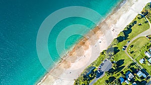 Aerial view on small suburb on a sunny ocean beach. Coromandel peninsula, New Zealand photo