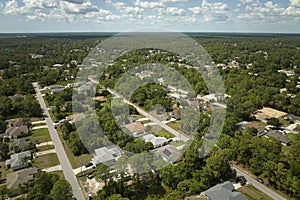 Aerial view of small town America suburban landscape with private homes between green palm trees in Florida quiet