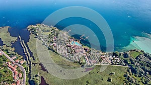 Aerial view of a small town on shore of a lake in green mountains