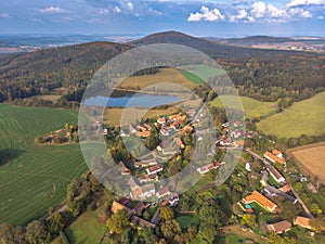 Aerial view of a small village hills in background.Top view of traditional housing estate in Czech.Houses from above, real estate