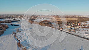 Aerial view of small village and roads in winter, winter landscape.