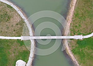 Aerial view of small walking bridge across lake