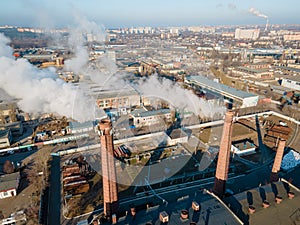Aerial view smoke clouds from boiler pipes on heating plant in city