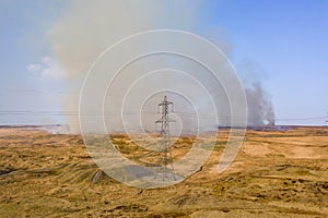 Aerial view of smoke and flames from a large grassfire on moorland in South Wales, UK Llangynidr Moors photo