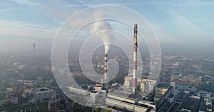 Aerial view of smoking chimneys of CHP plant and smog over the city and builidings in the background