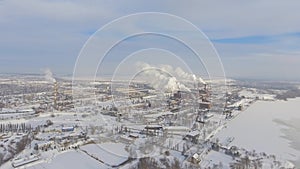 Aerial view of smoking pipes in industrial zone in winter