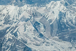 Aerial view of snow capped Himalayan mountains and glaciers on the flight from Tibet to Nepal.