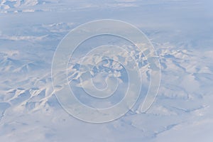 Aerial view of snow-capped mountains and clouds