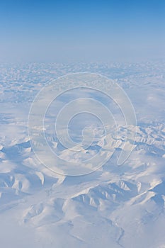 Aerial view of snow-capped mountains and clouds