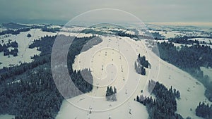 Aerial view of a snow covered alpine skiing slopes in winter. Ski resort in southern Poland, the Tatra mountains