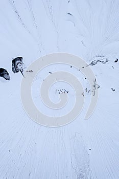 Aerial view of snow covered crater accessed by underground tunnels photo
