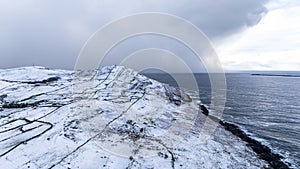 Aerial view of snow covered Dunmore Head, Bunaninver and Lackagh by Portnoo in County Donegal, Ireland.