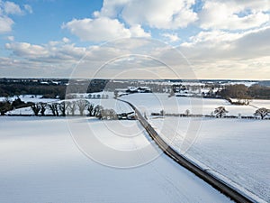 Aerial view of snow covered farm fields in the British countryside during a rare heavy snowfall known as the beast from the east