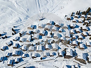 Aerial view of snow covered roofs over the traditional chalets