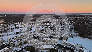 Aerial view snow covered rooftops of cottages townhouse settlement in winter