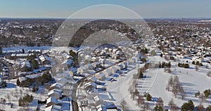 Aerial view snow covered rooftops of cottages townhouse settlement in winter