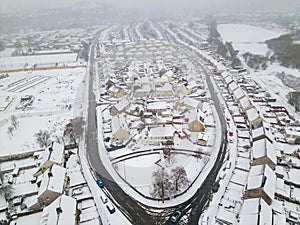 Aerial view of snow covered streets and roads during a blizzard (Wales