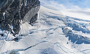 An aerial view of snow and crevasses on the peaks above the Denver glacier close to Skagway, Alaska