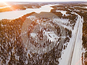 Aerial view of snow winter road and pine woods in Finland