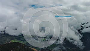 Aerial view of snowcapped mountains in clouds