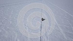 Aerial view snowmobiles ride on the frozen Lake Baikal in winter