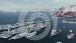 Aerial view of snowy Henningsvaer fishing village, Lofoten islands, Norway in winter at sunset