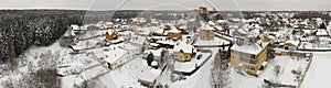 Aerial view on snowy houses on the winter woodside of snow forest.