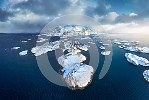 Aerial view of snowy Lofoten islands, Norway in winter at sunset