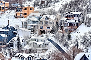 Aerial view of snowy neighborhood in winter on a mountain town with houses
