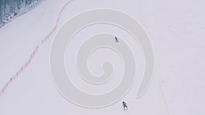 Aerial view of snowy skier ride alone on a mountain track